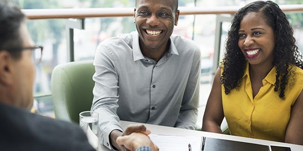 Satisfied couple meeting with an advisor